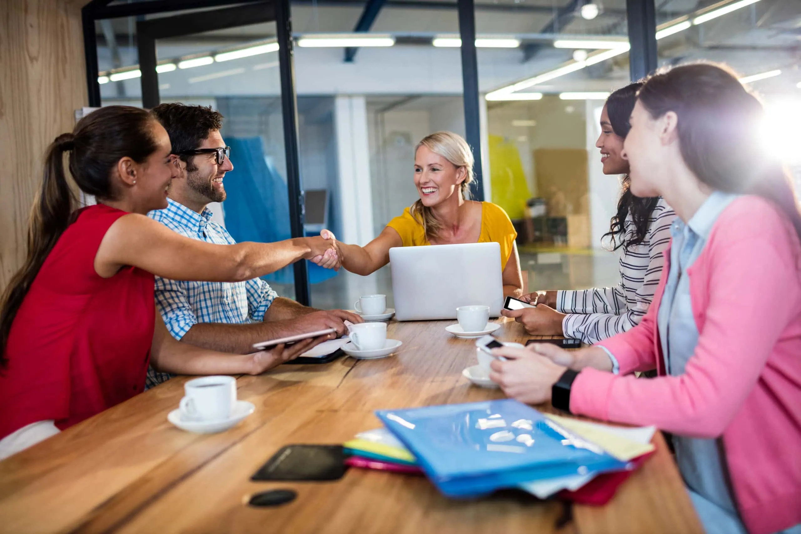 handshake as people are working together at a table